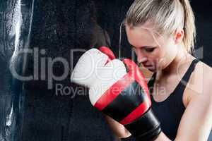 Boxing training woman with punching bag in gym