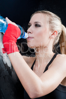 Boxing training woman pour water over mouth