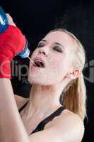 Boxing training woman pour water in her mouth
