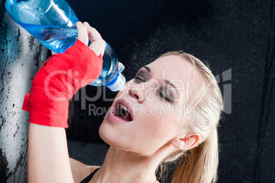 Boxing training woman pour water in mouth
