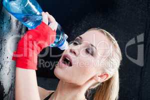 Boxing training woman pour water in mouth