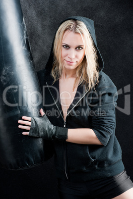 Boxing training woman in black hold punching bag