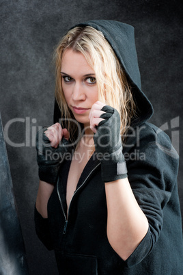 Boxing training woman in black grunge background