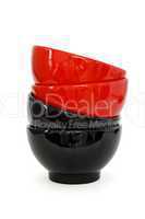 Zigzag stack of two red and two black porcelain bowls isolated