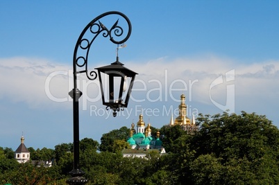 Retro street lantern and golden domes of Kiev Pechersk Lavra Monastery in Kiev, Ukraine