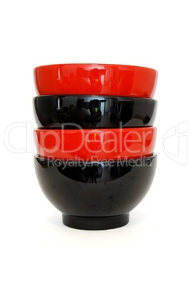 Stack of two red and two black porcelain bowls isolated