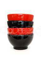 Stack of two red and two black porcelain bowls isolated