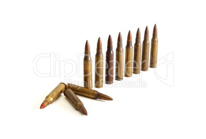 Row of standing  M16 cartridges with some fallen isolated