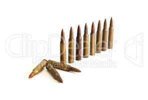 Row of standing  M16 cartridges with some fallen isolated