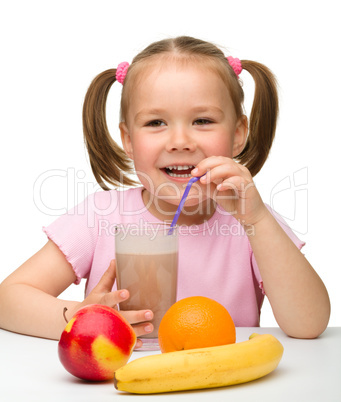 Little girl drinks fruit juice