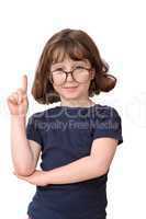 Little girl in round spectacles raising finger in attention gesture isolated