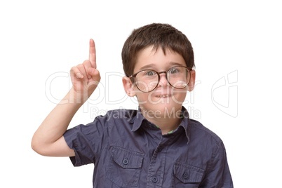 Little boy in round spectacles raising finger in attention gesture isolated