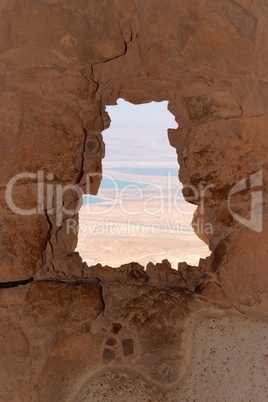 Dead Sea landscape seen through window of ruined Masada fortress