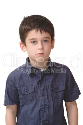 Serious cute little old boy stands isolated on white background