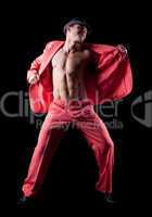 Strong young man dance in red costume