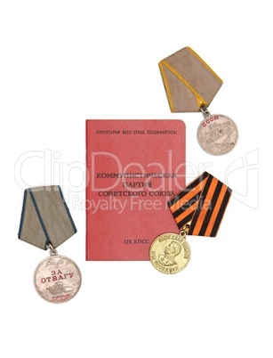 Soviet communist party membership card surrounded by old medals isolated