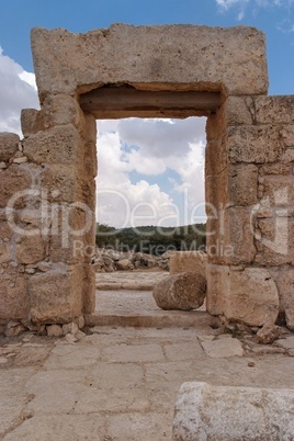 Stone entrance and wall of ruined ancient temple