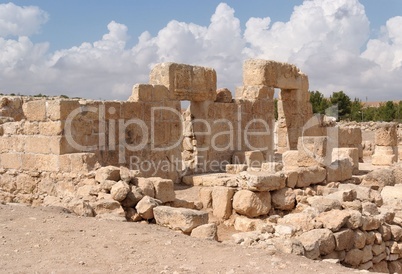 Stone entrance and wall of ruined ancient temple