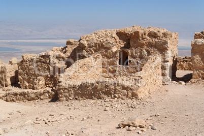 Ruins of ancient church Masada fortress on Dead Sea background