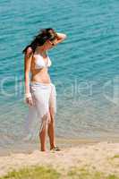 Summer toned woman walking beach in bikini