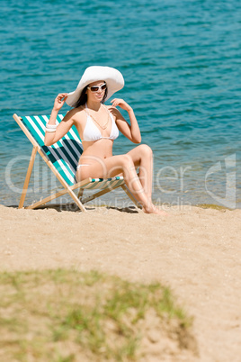 Summer slim woman sunbathing in bikini deckchair