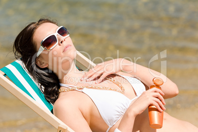 Summer young woman apply cream in bikini