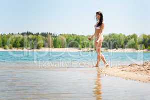 Summer beach woman walk sand wear bikini