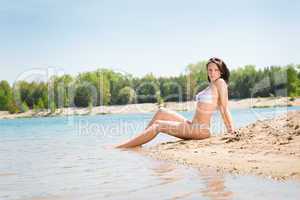 Summer beach stunning woman sitting in sand