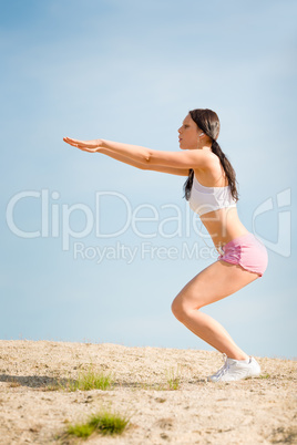 Summer sport fit woman stretching on beach