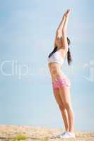 Summer sport fit woman stretching on beach