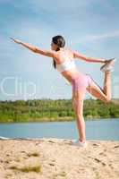 Summer sport fit woman stretching on beach