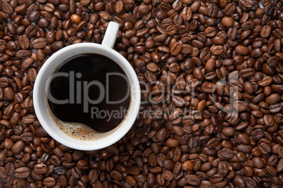 Coffee cup on background of beans