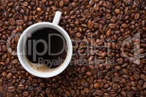 Coffee cup on background of beans