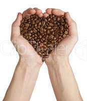 Heart shape made from coffee beans in hands
