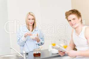 Breakfast happy couple eat cereal read newspaper
