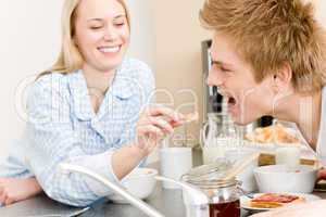 Breakfast happy couple woman feed man cereal