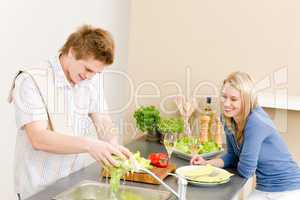 Lunch happy couple cook salad in kitchen