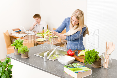 Lunch young woman cook salad wash lettuce