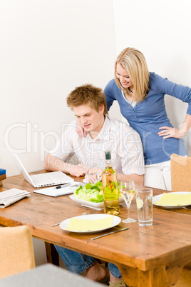 Happy couple man working on laptop kitchen