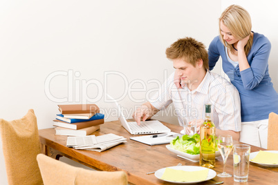 Happy couple man working on laptop kitchen