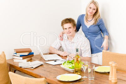 Happy couple man working on laptop kitchen