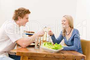 Happy couple enjoy wine eat salad kitchen