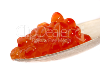 Red caviar on the spoon, on a white background