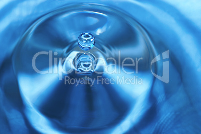 The round transparent drop of water, falls downwards.