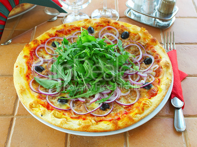 Hot pizza on a table in cafe