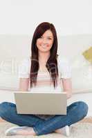 Attractive woman relaxing with her laptop while siting on a carp