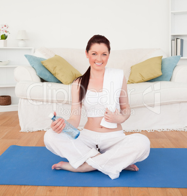 Smiling female having a rest after stretching while sitting on a