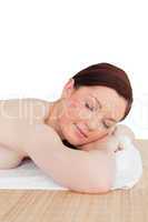 Good looking red-haired female relaxing in a spa centre