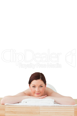 Charming red-haired woman relaxing in a spa centre