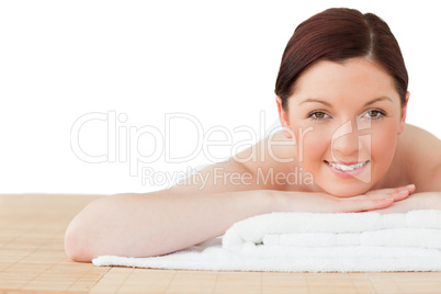 Young pretty red-haired woman posing while relaxing in a spa cen